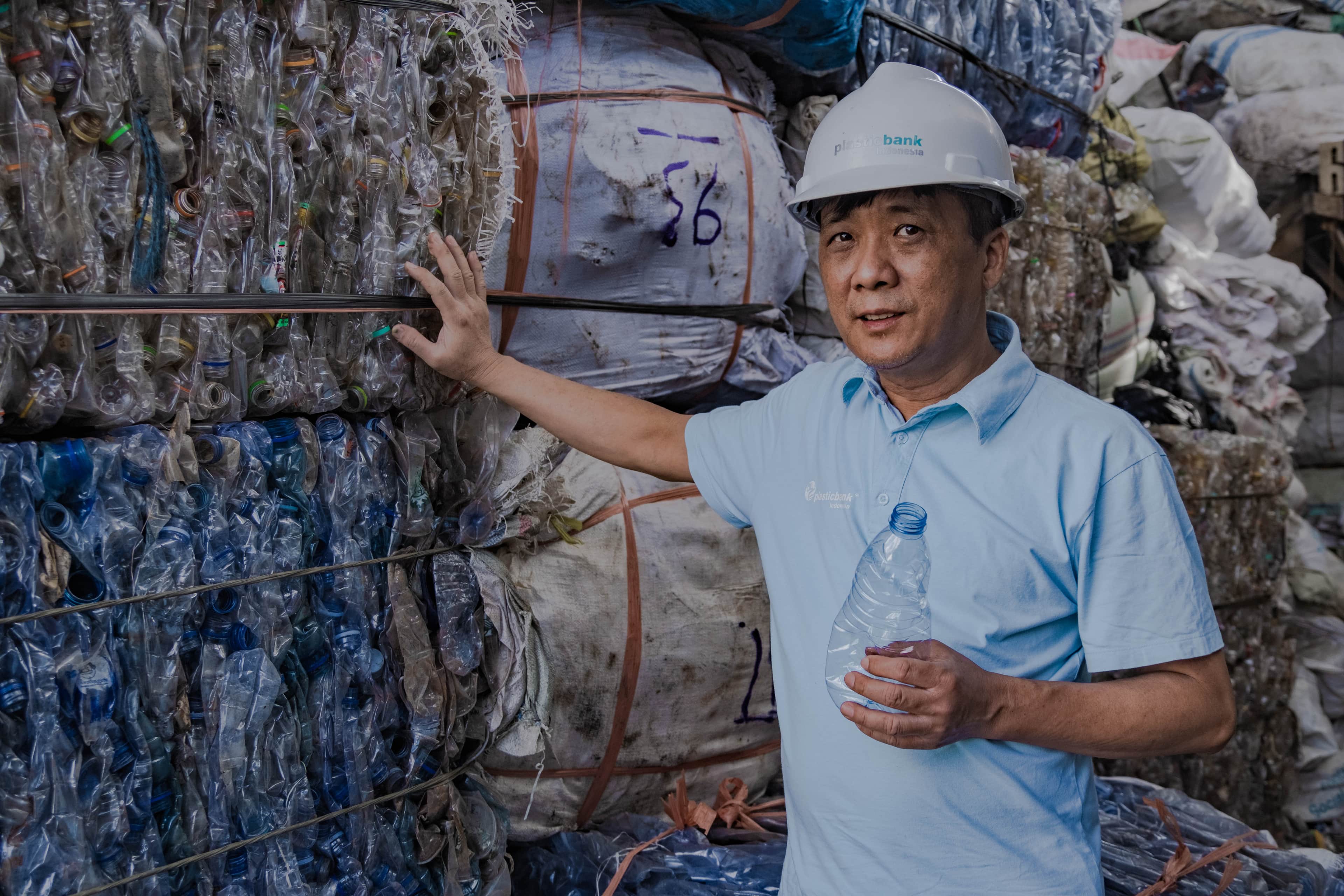 People gathering and recycling bottles as part of the Impact+ initiative