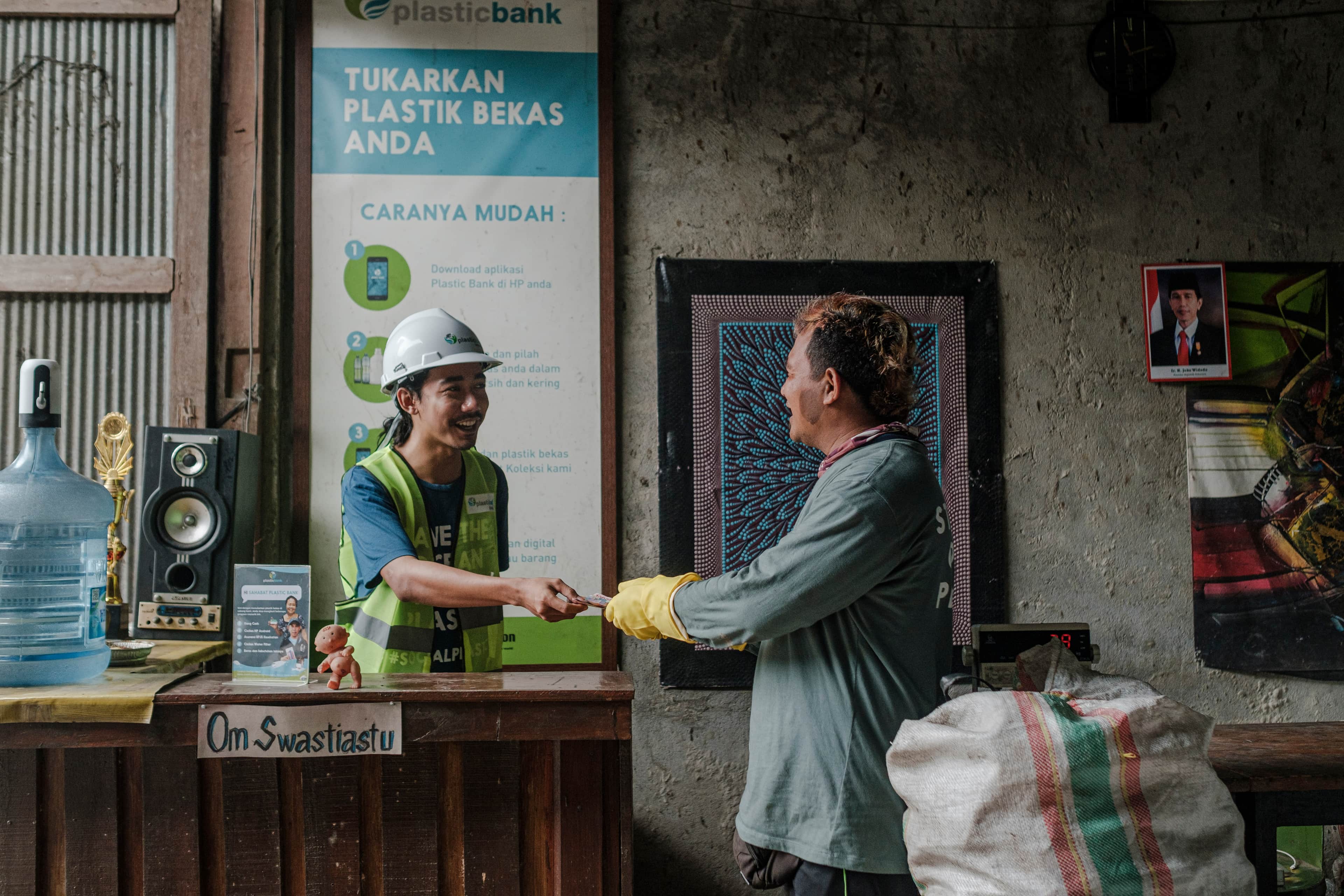 People gathering and recycling bottles as part of the Impact+ initiative