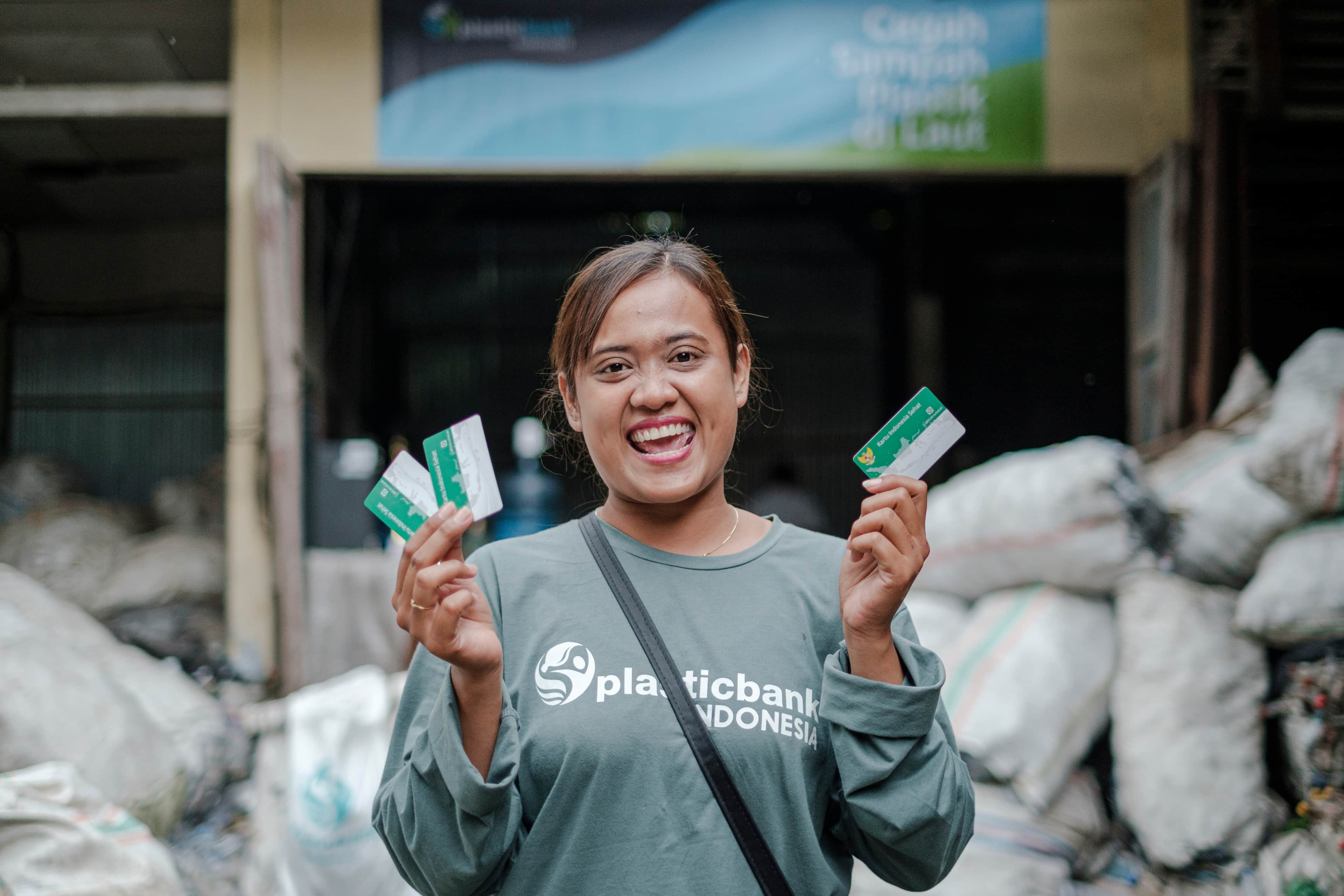 People gathering and recycling bottles as part of the Impact+ initiative